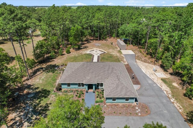 birds eye view of property with a view of trees