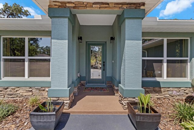property entrance with stone siding