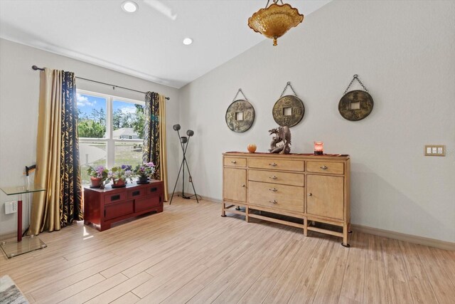 living area with recessed lighting, baseboards, and light wood-type flooring