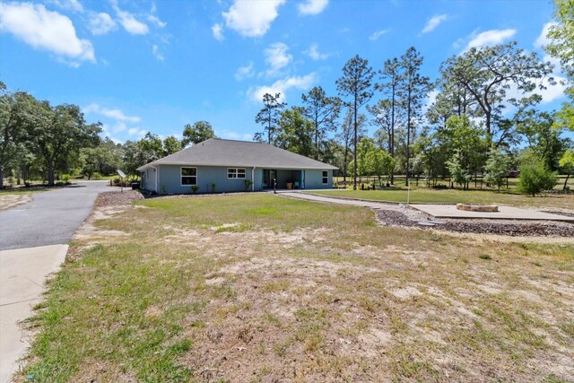 rear view of property with a lawn