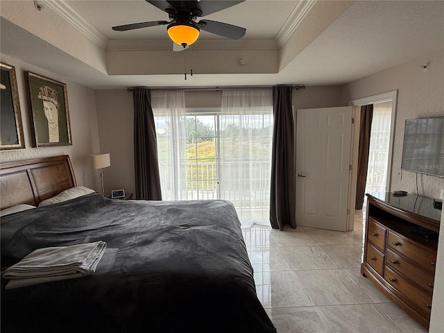bedroom with ornamental molding, access to exterior, a raised ceiling, a ceiling fan, and light tile patterned floors