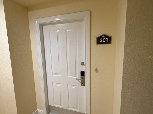 doorway to property with stucco siding