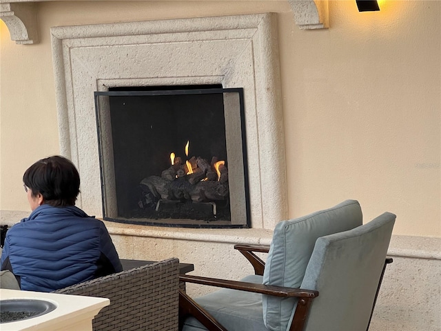 details featuring a warm lit fireplace