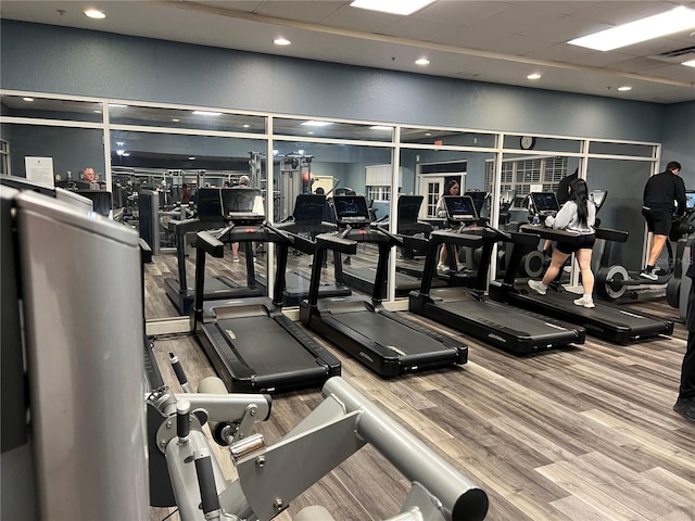 workout area with recessed lighting, wood finished floors, and visible vents
