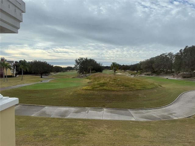 view of home's community featuring a lawn and golf course view