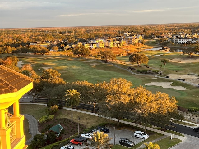 drone / aerial view featuring a residential view, a water view, and golf course view