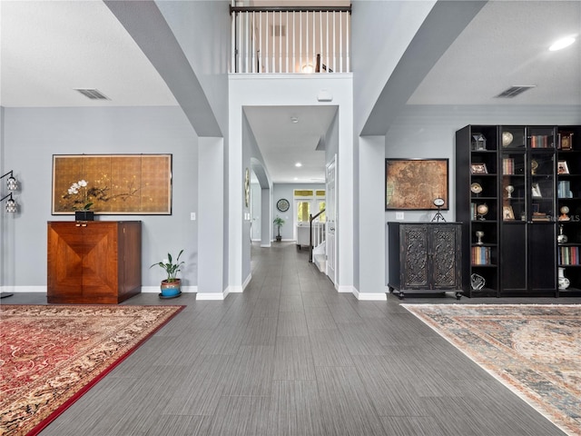 15242 Heron Hideaway Cir, Winter Garden, FL 34787 - foyer entrance featuring arched walkways, baseboards, and visible vents