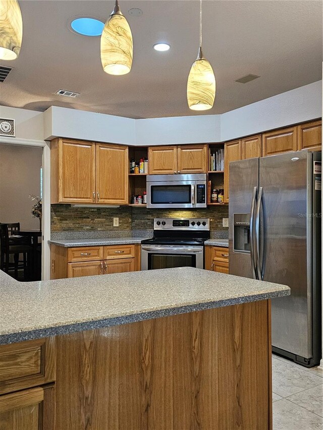 kitchen featuring appliances with stainless steel finishes, open shelves, backsplash, and brown cabinetry