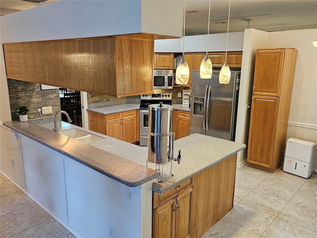 kitchen featuring appliances with stainless steel finishes, a sink, brown cabinetry, light tile patterned floors, and tasteful backsplash