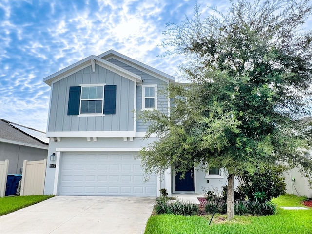 547 Jett Ln, Davenport, FL 33837 - view of front of property featuring board and batten siding, driveway, and an attached garage