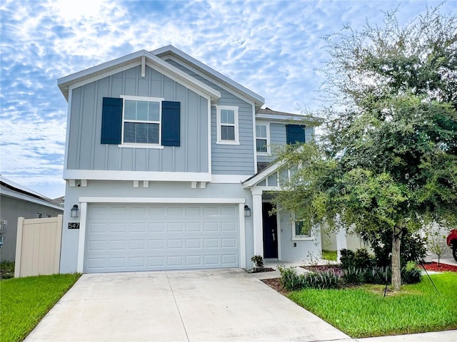 547 Jett Ln, Davenport, FL 33837 - view of front of home featuring board and batten siding, a garage, and concrete driveway