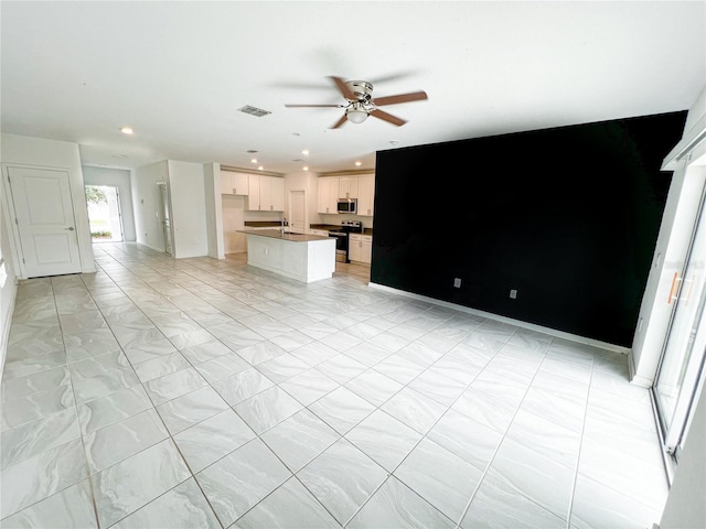 547 Jett Ln, Davenport, FL 33837 - unfurnished living room with ceiling fan and recessed lighting