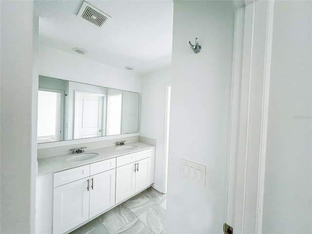547 Jett Ln, Davenport, FL 33837 - bathroom featuring double vanity and marble finish floors