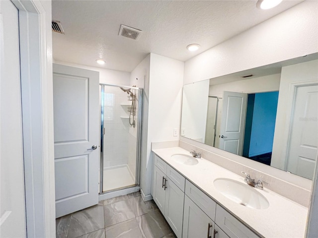 547 Jett Ln, Davenport, FL 33837 - bathroom featuring a shower stall, marble finish floors, double vanity, a textured ceiling, and recessed lighting