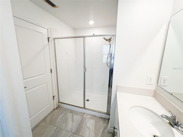 547 Jett Ln, Davenport, FL 33837 - bathroom featuring vanity, a shower stall, and marble look tiles