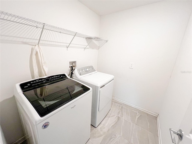 547 Jett Ln, Davenport, FL 33837 - laundry room with washer and dryer and light marble finish floors
