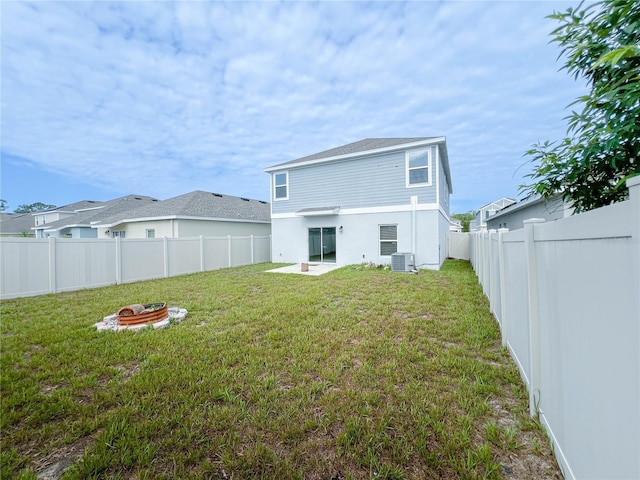 547 Jett Ln, Davenport, FL 33837 - back of property featuring a fenced backyard, an outdoor fire pit, and a patio area