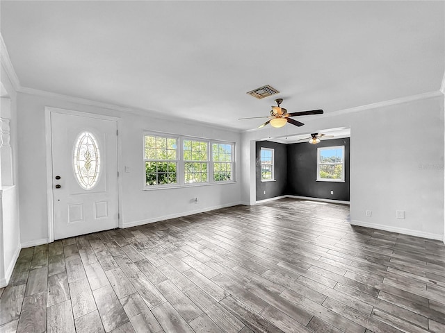 entrance foyer with a ceiling fan, visible vents, ornamental molding, and plenty of natural light