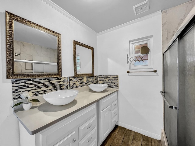 full bath featuring visible vents, a sink, decorative backsplash, and wood finished floors