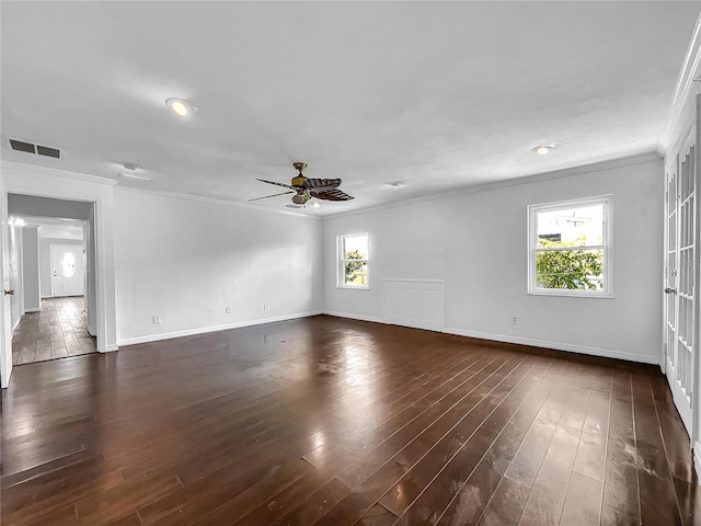 unfurnished room with crown molding, ceiling fan, visible vents, and baseboards