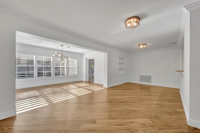1231 Glastonberry Rd, Maitland, FL 32751 - spare room featuring crown molding, built in shelves, baseboards, light wood-type flooring, and visible vents