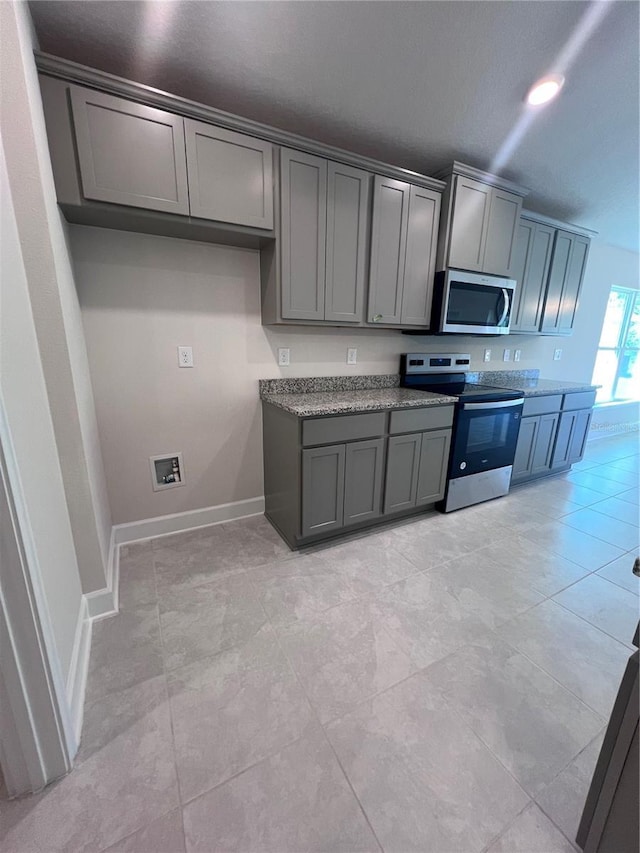 4264 Sagefield Dr, Saint Cloud, FL 34773 - kitchen with baseboards, appliances with stainless steel finishes, and gray cabinets