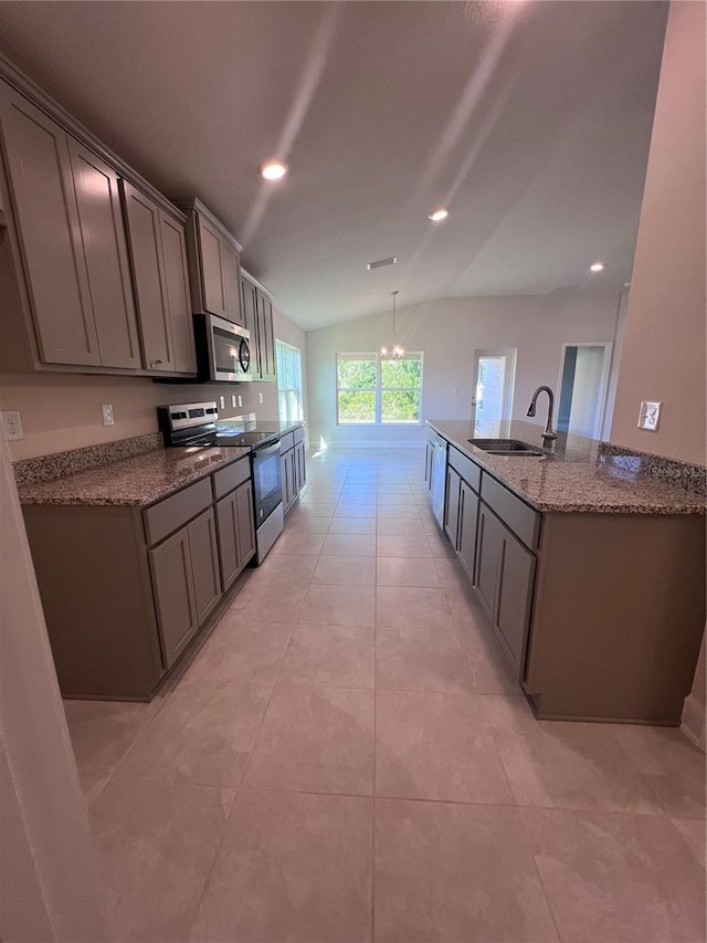 4264 Sagefield Dr, Saint Cloud, FL 34773 - kitchen with a sink, gray cabinetry, vaulted ceiling, and stainless steel appliances