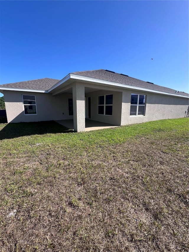 4264 Sagefield Dr, Saint Cloud, FL 34773 - back of property featuring a lawn, stucco siding, and a patio area