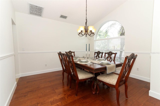 dining space featuring visible vents, a notable chandelier, and hardwood / wood-style floors