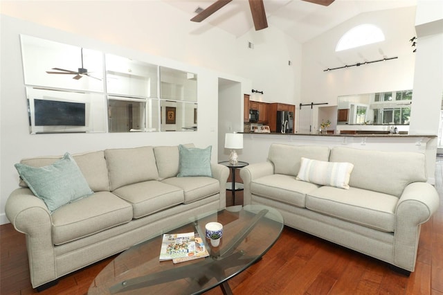 living room featuring ceiling fan, visible vents, high vaulted ceiling, and hardwood / wood-style floors