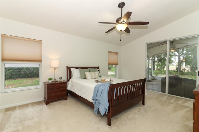 bedroom featuring lofted ceiling, light carpet, access to exterior, baseboards, and ceiling fan