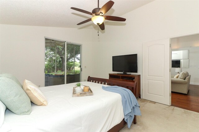 bedroom with access to outside, ceiling fan, carpet floors, and high vaulted ceiling