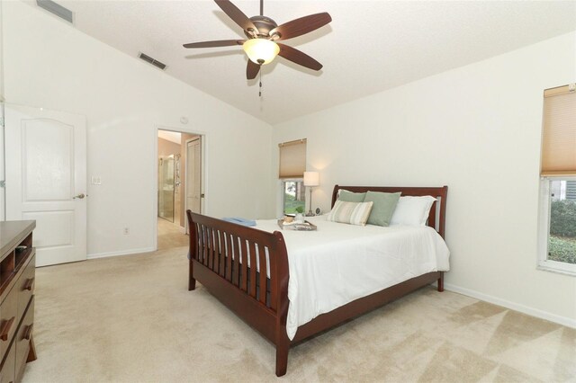 bedroom with multiple windows, light colored carpet, lofted ceiling, and visible vents