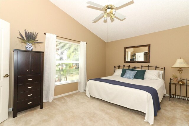 bedroom featuring baseboards, ceiling fan, lofted ceiling, and light colored carpet