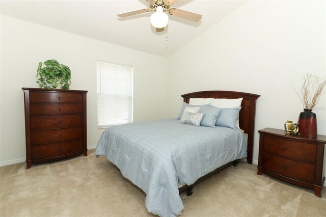 bedroom with a ceiling fan, baseboards, light colored carpet, and vaulted ceiling