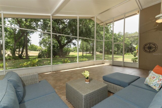sunroom / solarium with a ceiling fan