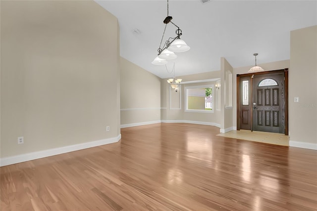 1512 Adriatic Dr, Ocoee, FL 34761 - foyer entrance featuring baseboards, an inviting chandelier, lofted ceiling, and light wood finished floors
