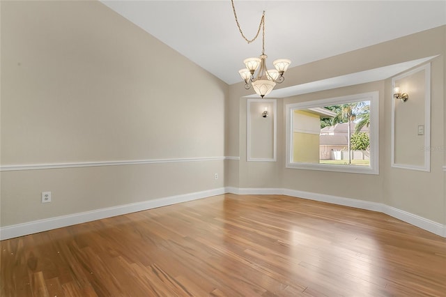 1512 Adriatic Dr, Ocoee, FL 34761 - empty room with baseboards, a chandelier, wood finished floors, and vaulted ceiling