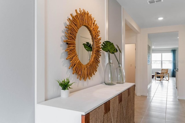 hallway with light tile patterned floors, recessed lighting, and visible vents