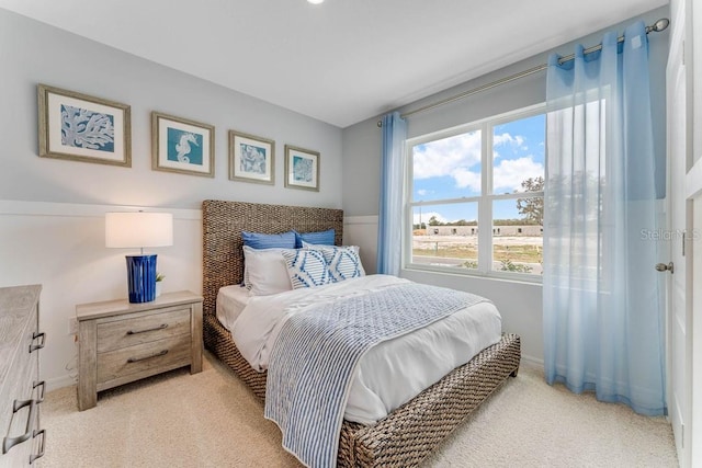 bedroom featuring baseboards and light carpet