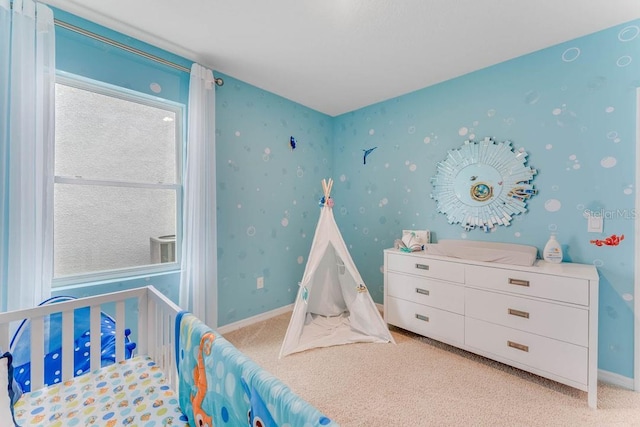 bedroom featuring baseboards and light carpet