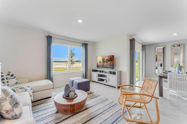 living area with recessed lighting and light tile patterned flooring