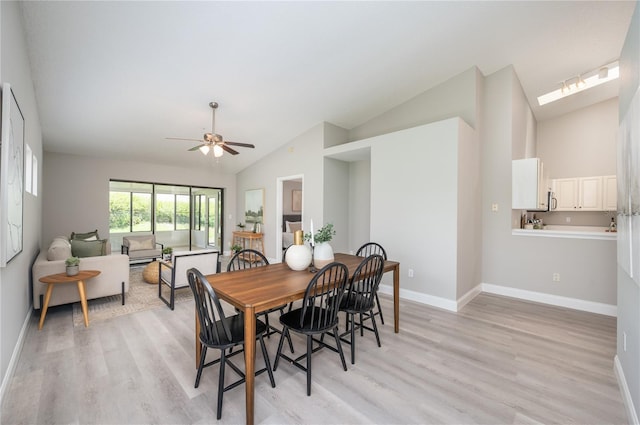 dining area with light wood-style floors, baseboards, and ceiling fan