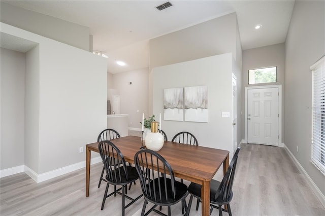 dining space featuring baseboards, light wood-type flooring, and visible vents