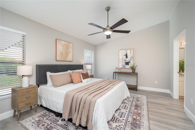 bedroom with a ceiling fan, baseboards, lofted ceiling, and light wood-type flooring