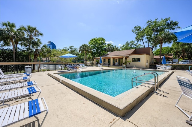 pool featuring fence and a patio