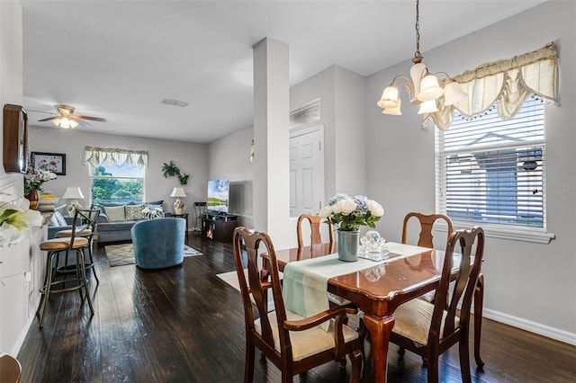 3917 Pemberly Pines Cir, Saint Cloud, FL 34769 - dining room featuring dark wood-style flooring, baseboards, visible vents, and ceiling fan with notable chandelier
