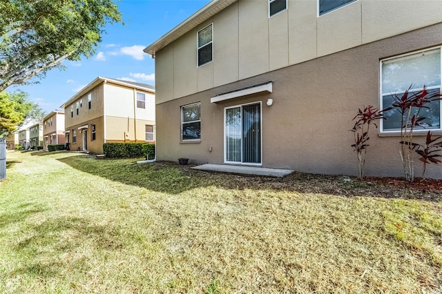 3917 Pemberly Pines Cir, Saint Cloud, FL 34769 - back of house with a lawn and stucco siding