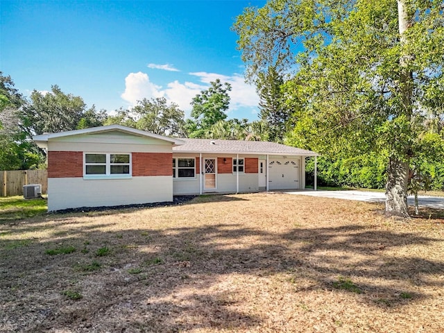 2631 Mcdonald Ter, Mount Dora, FL 32757 - view of front of home featuring fence, brick siding, a garage, cooling unit, and driveway