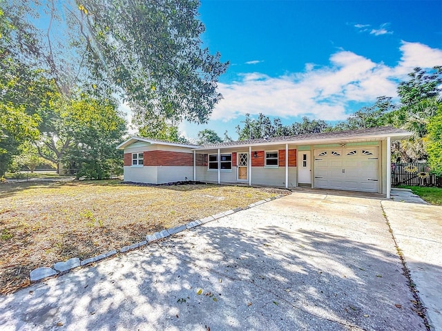 2631 Mcdonald Ter, Mount Dora, FL 32757 - ranch-style home with fence, an attached garage, and concrete driveway